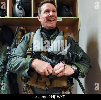 Royal Australian Air Force Wing Commander Stuart Seeney, 1 Squadron commanding officer, puts on his life support gear during RED FLAG-Alaska 22-3 at Eielson Air Force Base, Alaska, Aug. 4, 2022. RF-A serves as an ideal platform for international engagement, and the exercise has a long history of including allies and partners, ultimately enabling all involved to exchange tactics, techniques and procedures while improving interoperability. Stock Photo