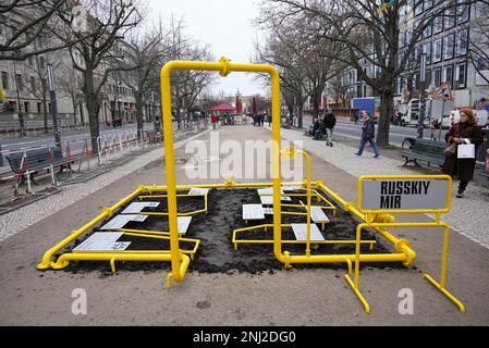 Berlin, Germany. 22nd Feb, 2023. A young woman walks by during the presentation of the art installation 'Russkij Mir' on Freedom Square in front of the Embassy of the Russian Federation. Credit: Soeren Stache/dpa/Alamy Live News Stock Photo
