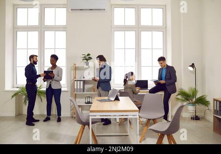 Group of multiracial business people working together in creative co-working space. Stock Photo