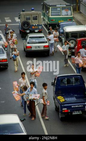 Indonesia, Jakarta. Children sell newspapers. Stock Photo