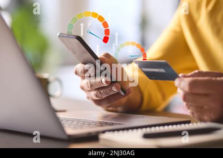 Man Using Mobile Phone App With Graphic Overlay Showing Energy Consumption And Credit Card Stock Photo