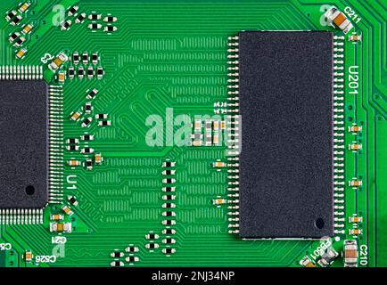 Semiconductor chips on electronic printed circuit board for high speed digital systems. Microchips on green PCB from computer network hardware device. Stock Photo