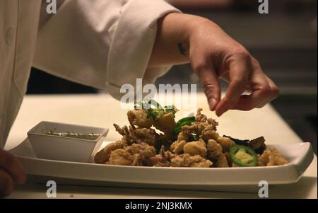 Executive chef Beatrice Dong Edrees prepares Muc Rang Muoi