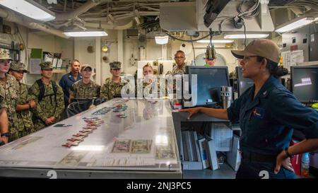 220805-N-BX517-1035 NAVAL STATION NORFOLK (August 5, 2022) Aviation Boatswain’s Mate 3rd Class Cynthia Trevizo assigned to the Nimitz-class aircraft carrier USS George H.W. Bush (CVN 77), discusses flight deck operations and safety in the Navy with a group of midshipmen during a tour of the ship, August 5, 2022. The visit was the last Career Orientation and Training for Midshipmen (CORTRAMID) summer training event for the students. George H.W. Bush provides the national command authority flexible, tailorable warfighting capability as the flagship of a carrier strike group that maintains mariti Stock Photo