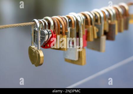 Wedding padlocks with heart shape on rope bridge Stock Photo