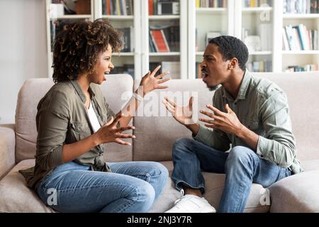 Black couple having argument on the couch at home Stock Photo