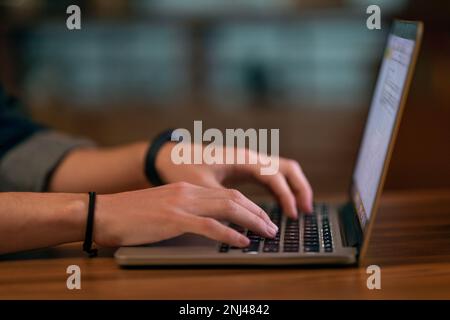 Unrecognizable man touching laptop computer keyboard, cropped Stock Photo