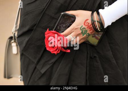 21 February 2023 in Sylhet-Bangladesh: A lady with red flower on hand at the Shahed Minar Presmies to pay tribute on the Martyr Monument on the occasion to observe International Mothers language Day 2023 and the Great Martyrs Day. Moreover, Schools, colleges, students, teachers, political and social, cultural organizations and all the professional people of the society offered floral tributes to the language martyrs and language fighters from the dawn at the Sylhet Central Shaheed Minar, Sylhet, Bangladesh, to observe the International Mothers Language Day and Great Martyr's Day. On 21 Febru Stock Photo