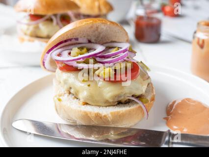 Homemade hamburger on kitchen table. Closeup front view Stock Photo