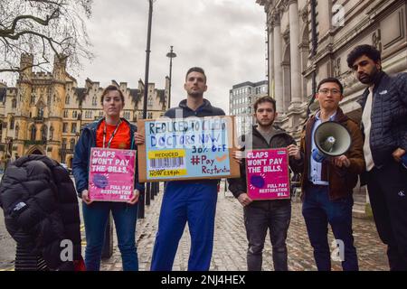 London, UK. 14th January 2023. Junior doctors hold placards ahead of the British Medical Association (BMA) Junior Doctors Committee rally at Central Hall Westminster, calling for full pay restoration. Stock Photo