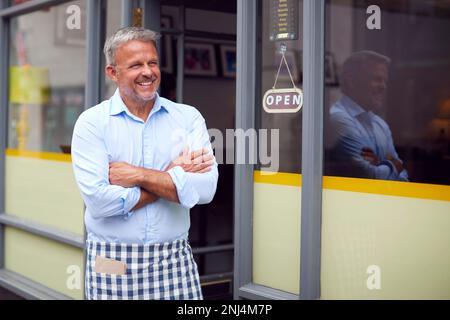 Portrait Of Male Owner Or Staff Standing Outside Coffee Shop Stock Photo