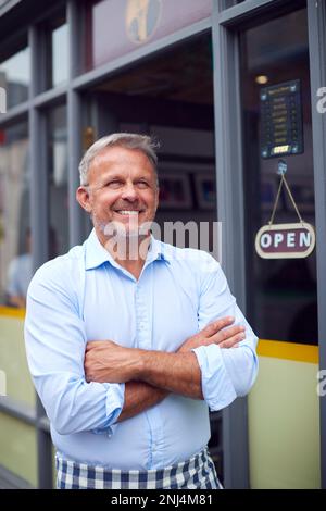 Portrait Of Male Owner Or Staff Standing Outside Coffee Shop Stock Photo