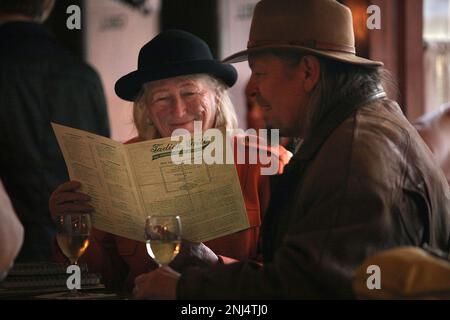 Annette Rose (left) and her husband Chris Hardman (right) having some wine and looking at the menu before being seated at Tadich Grill in San Francisco, Calif., on Thursday, December 15, 2011. (Liz Hafalia/San Francisco Chronicle via AP)