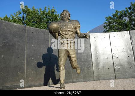 A memorial statue of Pat Tillman at State Farm Stadium reflection