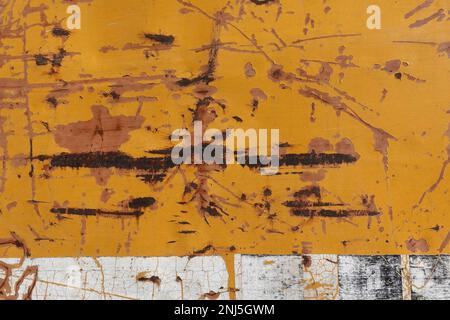 Metal background texture with rust chipped yellow paint and scratches. Stock Photo