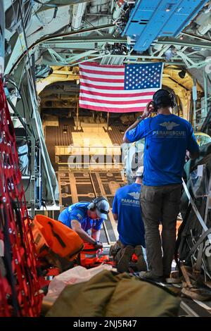 U.S. Air Force pararescuemen assigned with the 131st Rescue Squadron, 129th Rescue Wing, California Air National Guard, prepare for a parachute jump from an HC-130J Combat King II aircraft to provide emergency medical care to an injured crew member aboard a commercial fuel vessel on the Pacific Ocean, 800 nautical miles off the coast of San Francisco, to August 5, 2022.  (U.S. Air National Guard photo/video by Tech. Sgt. Deepak Prasad) Stock Photo