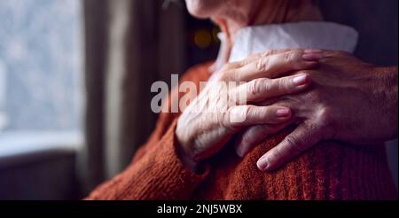 Close Up Of Senior Couple At Home With Man Putting Reassuring Hand On Woman's Shoulder Stock Photo