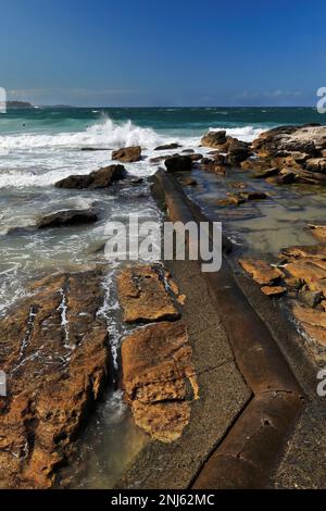 505 Strong waves break on the rocks next to Marine Parade in Manly suburb. Sydney-Australia. Stock Photo