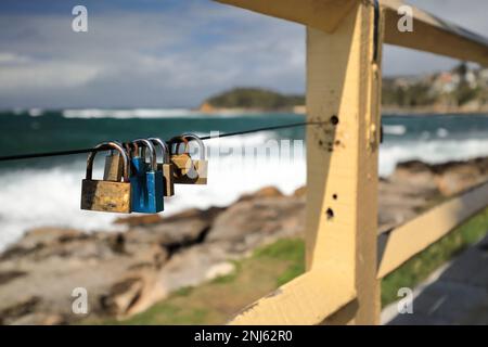508 Love padlocks on the yellow painted railing running along the Marine Parade-Manly suburb. Sydney-Australia. Stock Photo