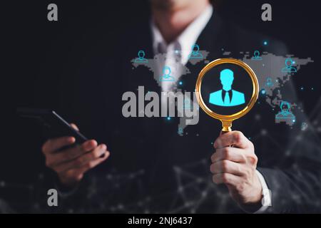 Businessman use magnifying glass for CRM, Customer Relationship Management. HR, human resource search personnel. Global structure customer network tec Stock Photo