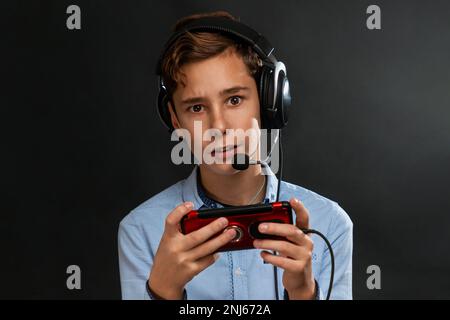 Teenager Boy Online Plays A Computer Game With Headphones And A