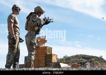 Reserve Citizen Airmen of 944th Fighter Wing Security Forces train and shoot simulated rounds out of an M203 grenade launcher attachment during heavy weapons qualifications at the Arizona National Guard Weapons Training Range in Florence, Ariz., Aug. 5, 2022. The simulated round from the grenade launcher bursts into orange smoke on impact giving the instructor and shooter an idea of where they hit. The Airmen qualified on the the M203 grenade launcher, and M240 and M249 machine guns. Stock Photo