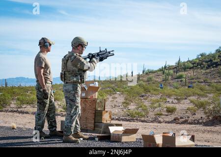 Reserve Citizen Airmen of 944th Fighter Wing Security Forces train and shoot simulated rounds out of an M203 grenade launcher attachment during heavy weapons qualifications at the Arizona National Guard Weapons Training Range in Florence, Ariz., Aug. 5, 2022. The simulated round from the grenade launcher bursts into orange smoke on impact giving the instructor and shooter an idea of where they hit. The Airmen qualified on the the M203 grenade launcher, and M240 and M249 machine guns. Stock Photo