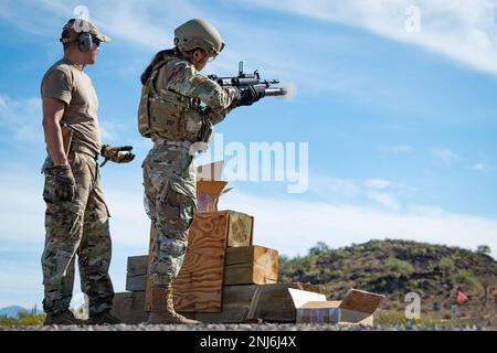 Reserve Citizen Airmen of 944th Fighter Wing Security Forces train and shoot simulated rounds out of an M203 grenade launcher attachment during heavy weapons qualifications at the Arizona National Guard Weapons Training Range in Florence, Ariz., Aug. 5, 2022. The simulated round from the grenade launcher bursts into orange smoke on impact giving the instructor and shooter an idea of where they hit. The Airmen qualified on the the M203 grenade launcher, and M240 and M249 machine guns. Stock Photo