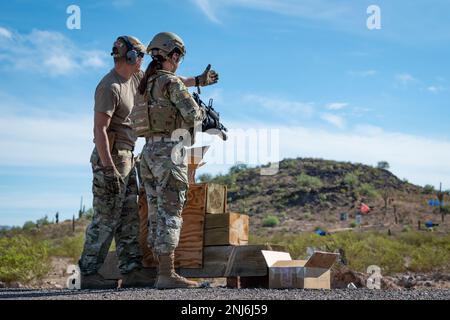 Reserve Citizen Airmen of 944th Fighter Wing Security Forces train and shoot simulated rounds out of an M203 grenade launcher attachment during heavy weapons qualifications at the Arizona National Guard Weapons Training Range in Florence, Ariz., Aug. 5, 2022. The simulated round from the grenade launcher bursts into orange smoke on impact giving the instructor and shooter an idea of where they hit. The Airmen qualified on the the M203 grenade launcher, and M240 and M249 machine guns. Stock Photo