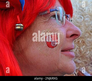 Enjoying the Mainz Fastnacht, Shrove Monday, woman in a red wig with temporary tattoo in red of the city coat of arms, Feb 2023 Stock Photo
