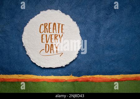 create every day - inspirational reminder or advice, handwriting on a circular sheet of watercolor paper against abstract landscape, creativity and pe Stock Photo