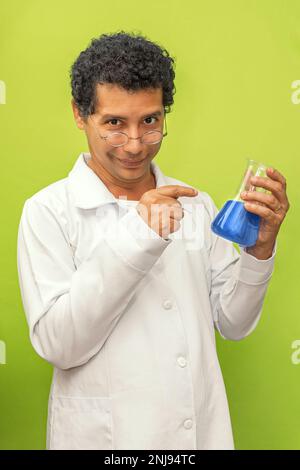 Portrait of a brazilian genius scientist happy with his science experiment on a green background, medical doctor with white coat Stock Photo