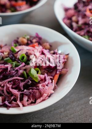 Home made vegan Red Cabbage, Chickpea Slaw with Sauerkraut, carrots and bell pepper. Stock Photo