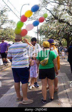 Man wearing a balloon hat he made for Mardi Gras day in New Orleans. Stock Photo