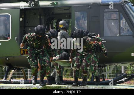 TNI Soldiers Evacuate An Injured Personnel To A Designated Location ...