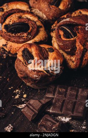 Delicious chocolate pastries on a table, with crumbs and broken pieces scattered around the surface Stock Photo
