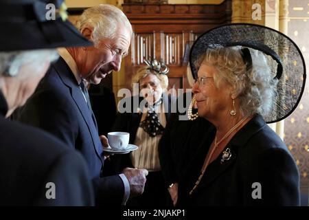 Britain's King Charles III speaks to the wives of victims of the Aberfan disaster during a reception for local charities at Cardiff Castle in Wales, Friday Sept. 16, 2022. The royal couple previously visited Scotland and Northern Ireland, the other nations making up the United Kingdom, following the death of Queen Elizabeth II at age 96 on Thursday, Sept. 8. (Chris Jackson/Pool via AP)