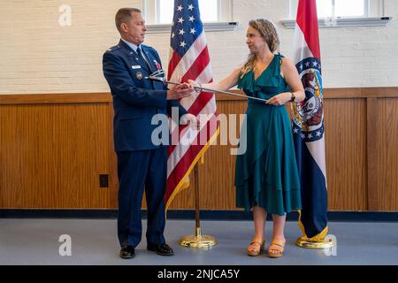 Lt. Col. William Skaggs, director of operations for the 157th Air Intelligence Squadron, receives a saber from his family, during his retirement ceremony, Aug. 6, 2022, at Jefferson Barracks Air National Guard Base, St. Louis, Missouri. Skaggs served for 37 years. Stock Photo