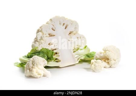 Halved cauliflower and two pieces or florets, healthy vegetable ingredient, food and cooking concept, isolated with small shadows on a white backgroun Stock Photo
