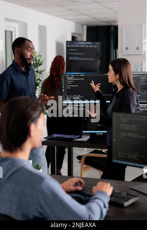 Software developer programming source code algorithm on computer, typing sever data in agency office. Database programer working on new user interface with online system to create algorithm. Stock Photo