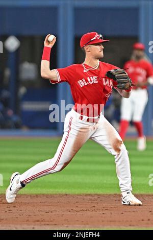 Toronto Blue Jays second baseman Cavan Biggio (8) throws to first base  during a spring training baseball game against the Baltimore Orioles on  March 1, 2023 at Ed Smith Stadium in Sarasota