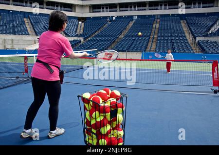 Toronto, Ontario / Canada - May 28, 2017:  Mother and girl playing tennis on the indoor tennis court Stock Photo