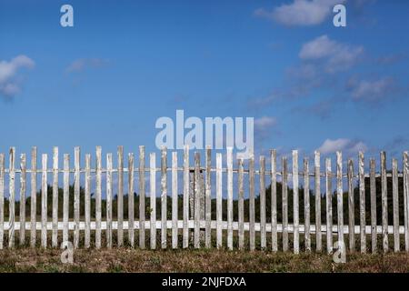 A Rustic old wooden fence protecting peaceful New England meadow Stock Photo