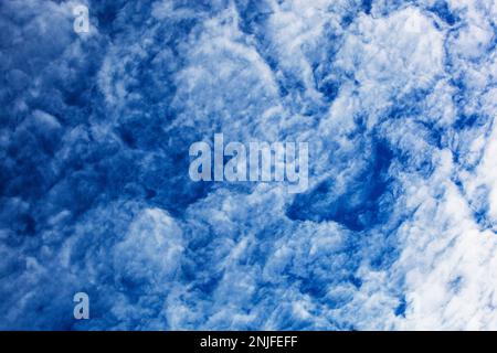 Cumulonimbus clouds form a beautiful pattern against a blue sky Stock Photo
