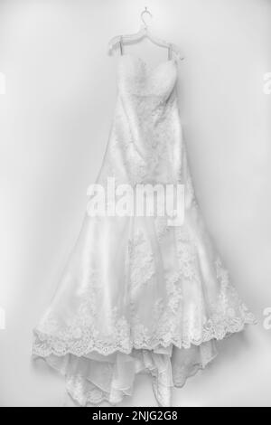 White wedding dress on hanger with lace bodice Stock Photo