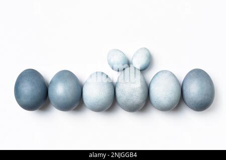 Easter eggs in row, one is standing out with bunny ears. Stock Photo