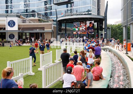 ATLANTA, GA - AUGUST 21: Fans line up to get inside Truist Park at The Chop  House Gate in The Battery Atlanta prior to the Sunday afternoon MLB game  between the Houston