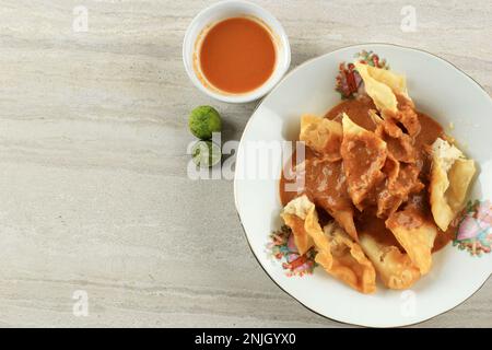 Batagor Baso Tahu Goreng, Deep Fried Fish Dumpling with Peanut Sauce and Soy Sweet Sauce. Popular Street Food from Bandung Stock Photo