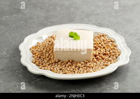 White Tofu with Soy Bean on Ceramic Plate, Tahu Sutera Putih, Asian Style Beancurd Stock Photo