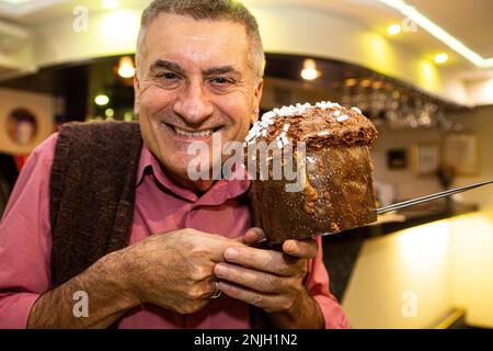 Italian maestro restorateur and skillful baker Walter shows freshly baked panettone in one of the best Italian places in Ukraine ristorante Walter Stock Photo